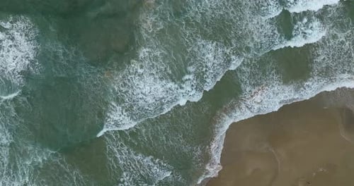 Ocean waves breaking on a rocky shore, Aerial view.
