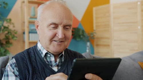 Senior Man Using Tablet at Home