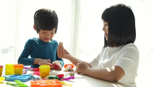 Children Creatively Play with Colorful Clay Indoors
