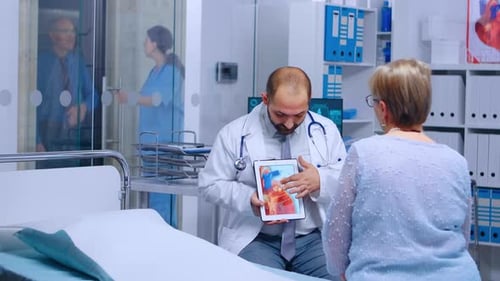 Doctor Explaining Heart X-Ray to Senior Patient