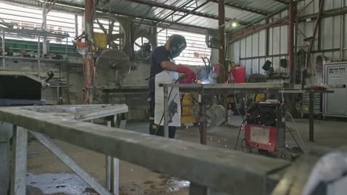 Skilled Worker Welding Metal in a Workshop
