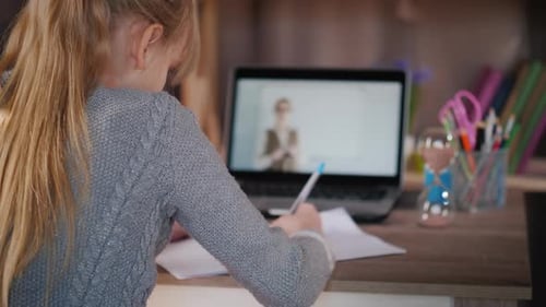 Young Girl Engaged in Online Learning at Home