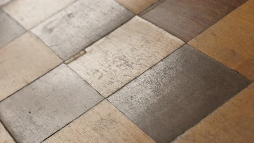 Close-up of checkered board game patina and traces of use 4K 2160p 30fps UltraHD tilting footage -