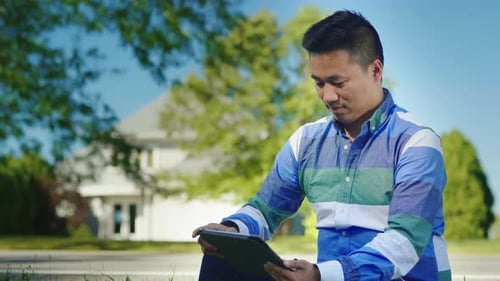 Asian Man Working with Tablet