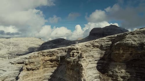 Zoom in Drone Shot of Hands Raised Woman Standing on the Top of Piz Boe Mountain