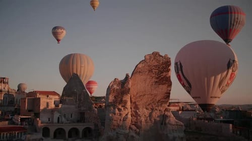 Hot air balloons seen from a cave hotel in Goreme, Cappadocia, at sunrise