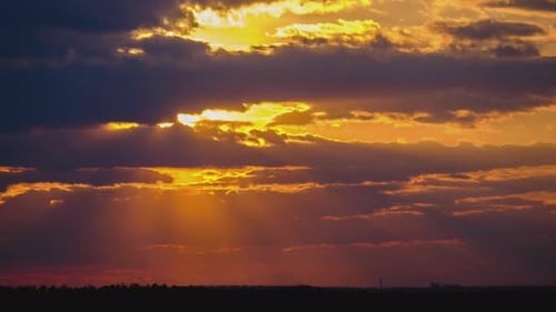 Sunset in the Sky Through Yellow Layered Clouds Timelapse