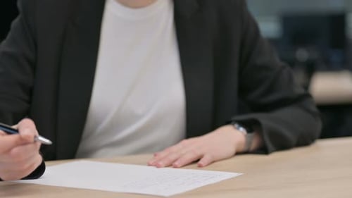 Close Up of Female Hands Writing on Paper