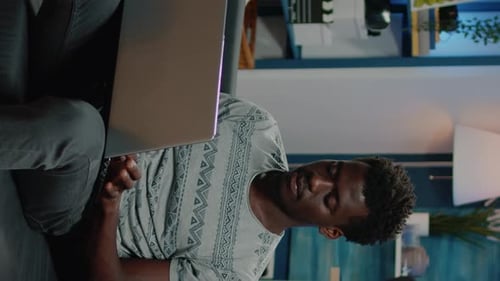 Man Working on Laptop Computer at Home