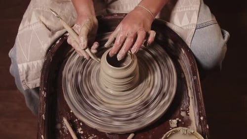 Pottery Workshop Female Hands Shaping the Clay on the Wheel Using a Tool