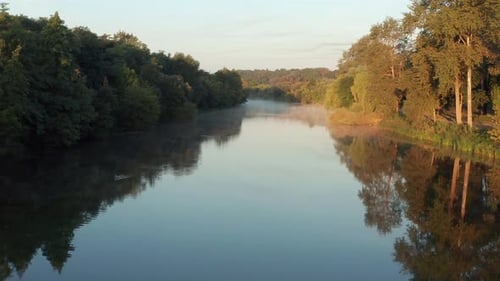 Beautiful morning, summer flight over the river. Fog, trees.