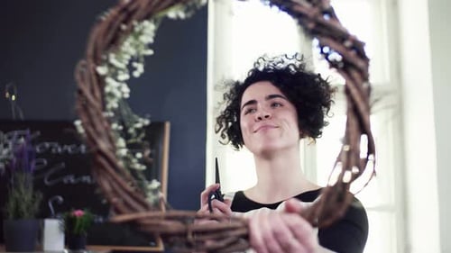 Woman Crafts Floral Wreath in Flower Shop