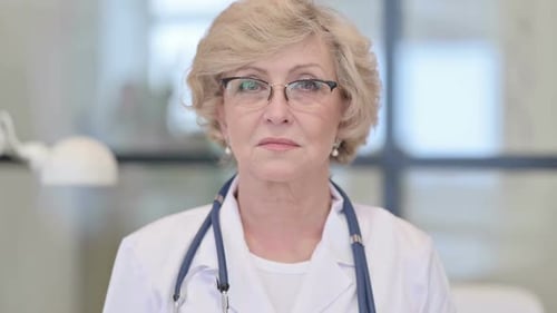 Senior Woman Doctor in White Coat Close-up
