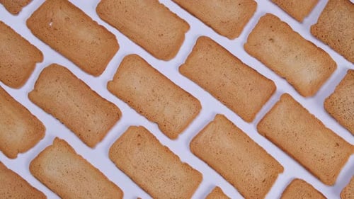 Arrangement of Golden Brown Rusks on White Background