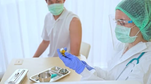 Medical Professional Prepares Injection in Hospital Setting