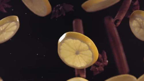 Floating Lemon Slices and Cinnamon Sticks on Black