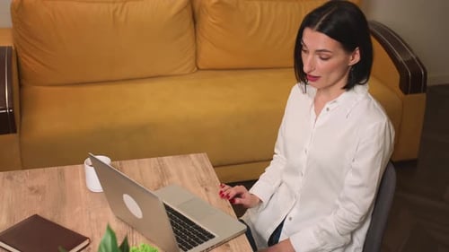 Young Woman Video Calling at Home on Laptop