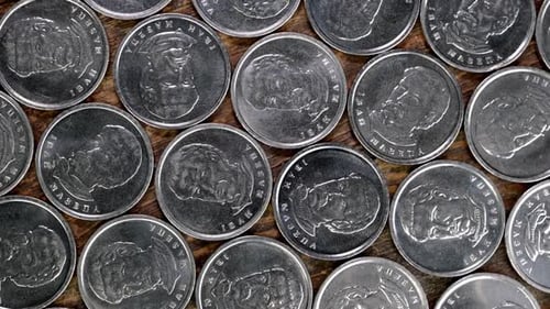 Overhead Display of Silver Coins on Wood Surface