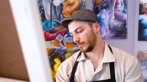 Young Artist Concentrating on His Painting