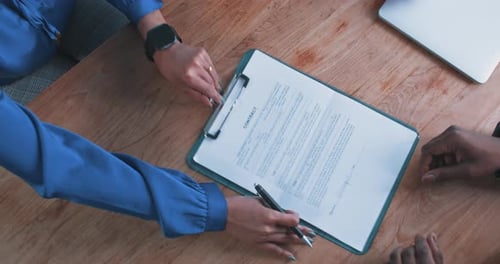 Close up of a busineswoman handing over a contract to a businessman