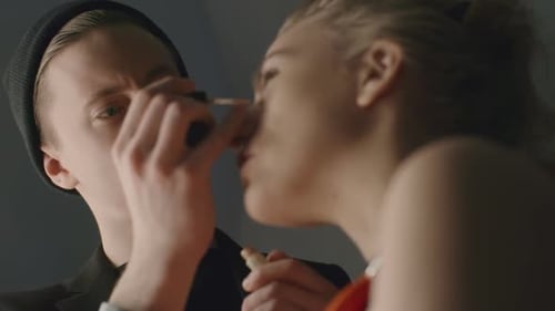 Makeup Artist Applying Makeup to Female Model