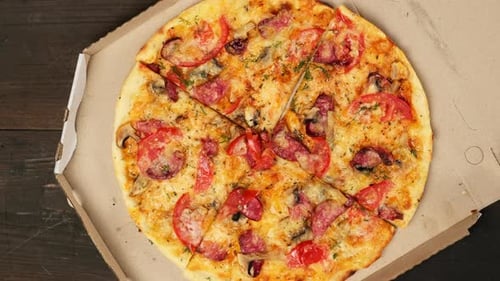 Delicious Pizza with Sausage and Tomatoes in Box