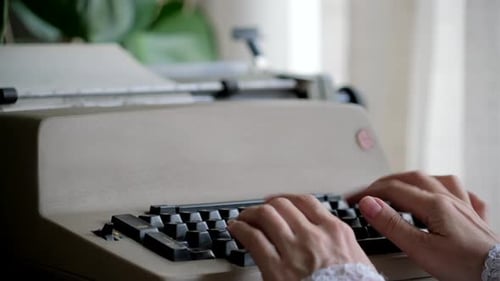 Hands Typing on Vintage Typewriter