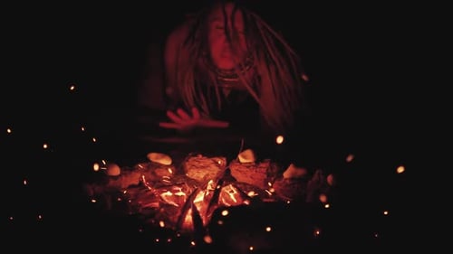Scary Witch Does Voodoo Black Magic Ritual Near the Fire at Night