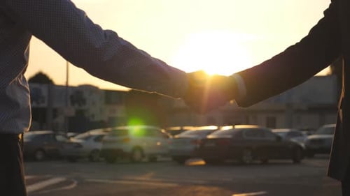 Business People Handshake at Sunset