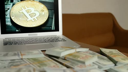 Stacks of Money and Laptop with Bitcoin Image