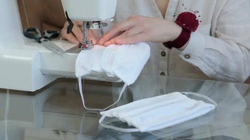Woman Sewing Fabric Masks on Sewing Machine