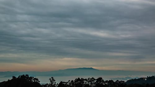 Scenic Sunset Over Mountain Range with Cloudy Sky