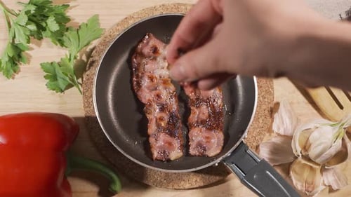 Crispy Bacon Cooking in Pan with Fresh Ingredients