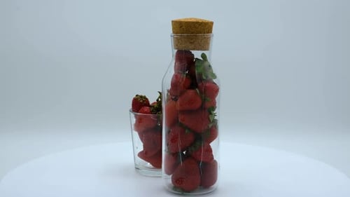Fresh Strawberries in Glass Bottle and Glass