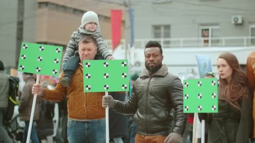 Diverse Group with Green Screen Signs Marching