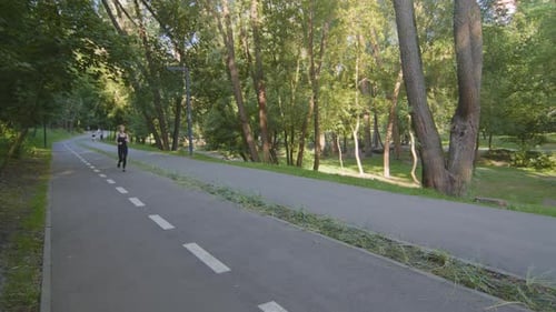 Blond Slender Strong Woman Caucasian Lady Runner Athlete in Black Tracksuit Runs Marathon Speed