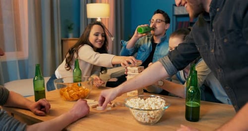 Friends Playing a Table Game Drinking Beer