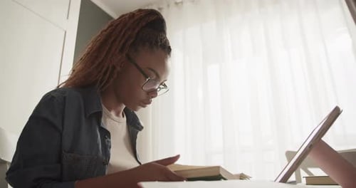 Young Woman Reading a Book at Home