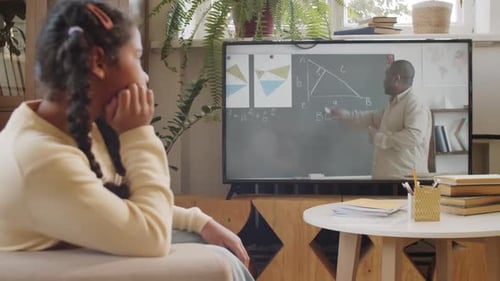 Girl Watching a Math Lesson on Television