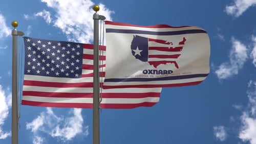 Waving United States and Oxnard City Flags against Blue Sky