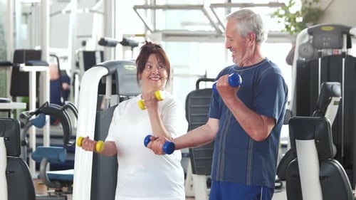 Active Senior Couple Working Out Together at the Gym