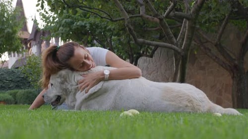 Woman Gives Dog a Kiss and Cuddle, Close Loving Relationship Between Pet and Owner.