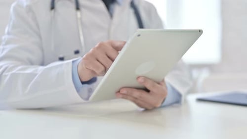 Close Up of Doctor Using Tablet