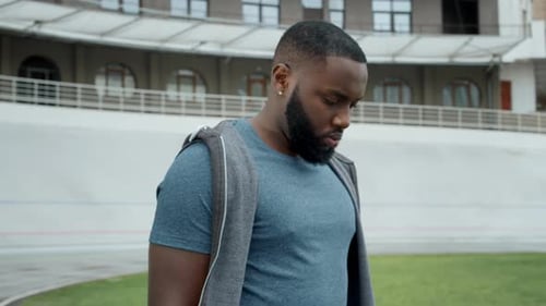 Sportsman Getting Message on Smartwatch. Runner Using Smart Watch at Racetrack