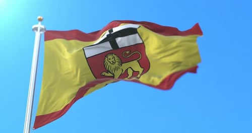 Realistic Waving Flag with Heraldic Coat of Arms Against Blue Sky