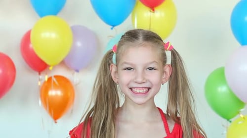Smiling Girl with Balloons Celebrates Birthday