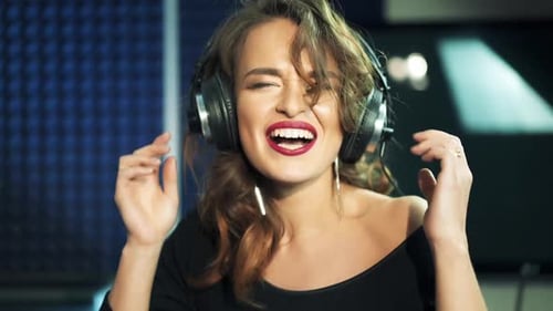 Professional recording studio. Girl in the headphones sings. Close-up