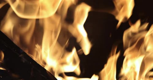 Home Fire Glowing Pieces in Fireplace with Burning Wood