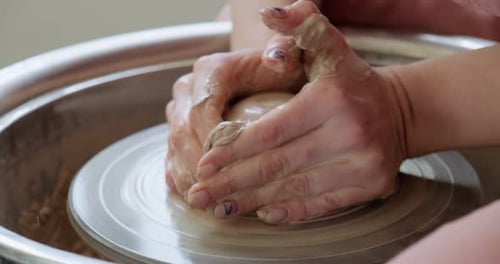 Hands Shaping Clay on Pottery Wheel Close Up