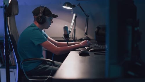 Young Adult Gaming at Computer at Night